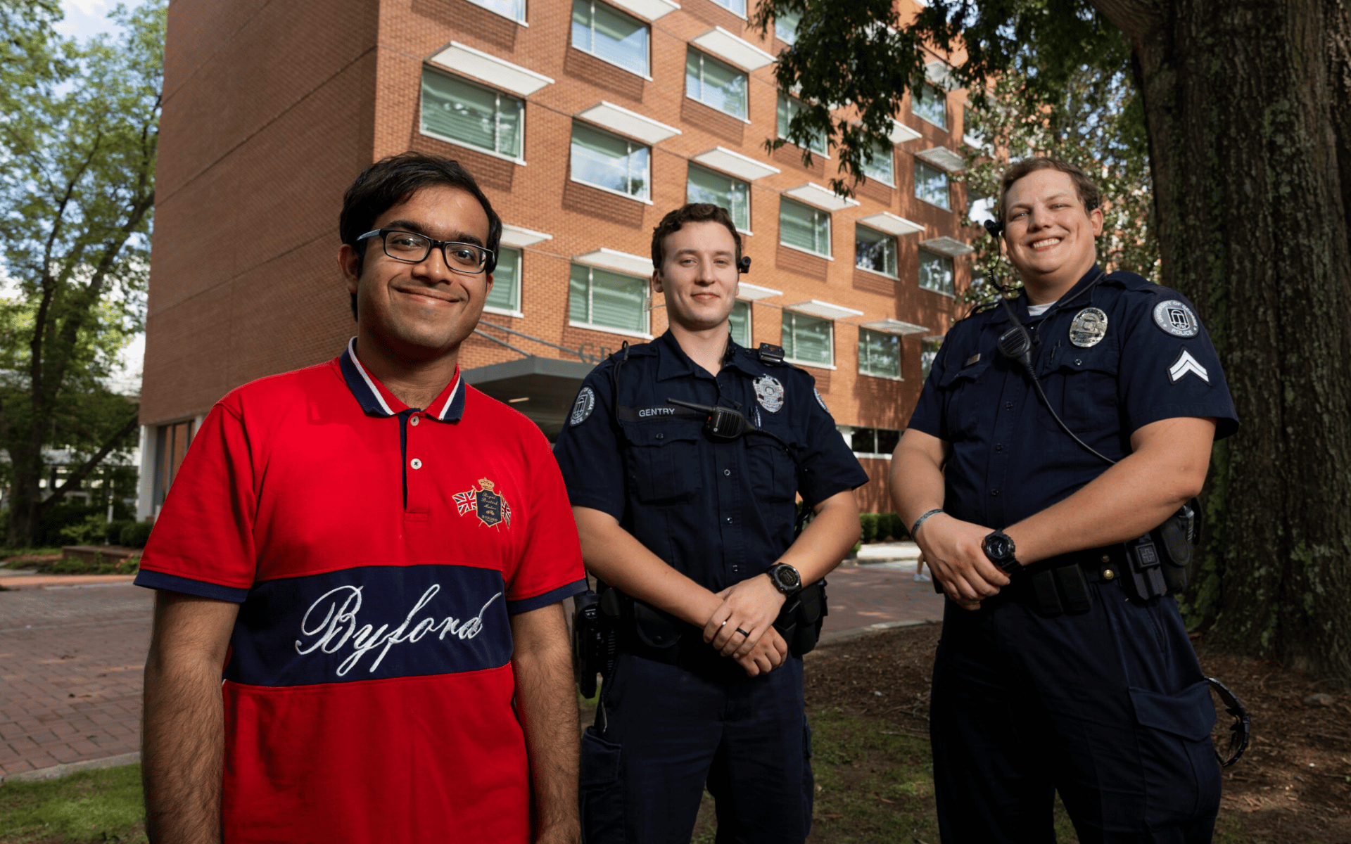 A photo of a UGA student with two UGAPD members who helped him