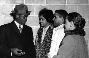 A group of people gather at the UGA Main Library.